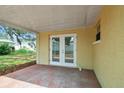 Cozy covered patio area with brick flooring, offering a relaxing outdoor space at 5033 Tammy Ln, Holiday, FL 34690