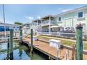 View of a boat dock with lush green landscaping and waterfront property at 5037 Starfish Se Dr # A, St Petersburg, FL 33705