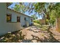 Backyard of home showing landscaped areas and a utility building at 5806 N 9Th St, Tampa, FL 33604
