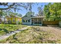 Quaint one-story home featuring a lush front lawn and inviting curb appeal in a sunny neighborhood at 5806 N 9Th St, Tampa, FL 33604