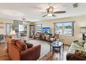 Spacious living room with wood-look floors, ceiling fans, and plush seating creates a cozy and inviting atmosphere at 5980 Terrace Park N Dr # 214, St Petersburg, FL 33709