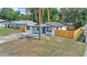 Aerial view showcases a charming single-story home with a fenced yard, driveway and landscaping at 4210 E Grove St, Tampa, FL 33610