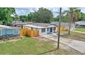 A quaint home with a fenced-in yard, and a tidy lawn at 4210 E Grove St, Tampa, FL 33610