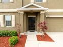 A close-up of the home's front door, showcasing a welcoming entrance and tidy landscaping at 12607 Flatwood Creek Dr, Riverview, FL 33578
