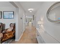 Inviting hallway with neutral tones, tile flooring, and elegant decor at 12607 Flatwood Creek Dr, Riverview, FL 33578