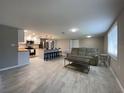 Spacious open-concept living room with modern tile flooring seamlessly connected to a well-equipped kitchen at 12907 College Hill Dr, Hudson, FL 34667