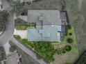 Overhead aerial view showcasing property lines, green roof, surrounding landscape, and neighborhood layout at 13209 Palmilla Cir, Dade City, FL 33525