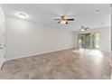 Spacious living room boasts tile floors and sliding glass doors for natural light and outdoor access at 13233 Canopy Creek Dr, Tampa, FL 33625