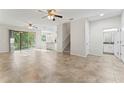 Bright, open living room features tile floors, ceiling fans, and sliding glass doors to the outdoors at 13233 Canopy Creek Dr, Tampa, FL 33625
