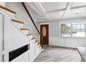 Inviting foyer with staircase, coffered ceilings, wood-look flooring, and a stylish front door at 1810 Maryland Ne Ave, St Petersburg, FL 33703