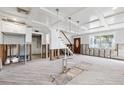 Open-concept room with staircase, large windows, and coffered ceiling during renovation at 1810 Maryland Ne Ave, St Petersburg, FL 33703