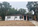 Charming single-story home featuring a carport and freshly painted exterior at 2312 W Kenmore Ave, Tampa, FL 33604