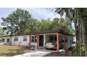 Charming single-story home featuring a carport, freshly painted exterior, and well-manicured lawn at 2312 W Kenmore Ave, Tampa, FL 33604