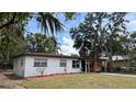 Charming single-story home featuring a carport, freshly painted exterior, and well-manicured lawn at 2312 W Kenmore Ave, Tampa, FL 33604