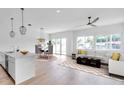 Bright open-concept living and dining area with modern furnishings and ample natural light streaming through the windows at 2608 W Columbus Dr # 1, Tampa, FL 33607