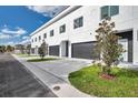 Row of modern townhouses with clean architectural lines and landscaping, presenting a contemporary street appeal at 2608 W Columbus Dr # 1, Tampa, FL 33607