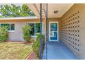 Close up view of the front porch with a secure screen door, and decorative concrete block accent at 2933 Stratford Dr, Largo, FL 33771