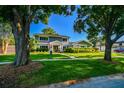 Attractive two-story home with a well-maintained lawn and mature trees, creating a welcoming curb appeal at 3304 Latania Dr, Tampa, FL 33618