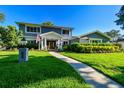 Charming two-story home with landscaped yard and walkway leading to the entrance, all under a clear blue sky at 3304 Latania Dr, Tampa, FL 33618