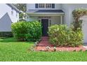 Inviting front porch with a brick pathway, lush greenery, and a stylish entryway at 3619 W Leona St, Tampa, FL 33629