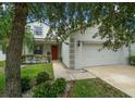 Charming two-story home featuring a two-car garage, well-maintained lawn and mature trees in a Gathering-friendly neighborhood at 396 Winthrop Dr, Spring Hill, FL 34609