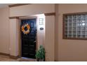 Charming condo front door featuring a welcoming wreath, unit number, and a stylish decor plant at 4221 W Spruce St # 1303, Tampa, FL 33607