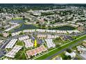 Aerial view of a community featuring multiple ponds, lush landscaping, and numerous residential buildings at 4345 Tahitian Gardens Cir # C, Holiday, FL 34691