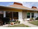 Inviting front porch with various potted plants and exterior decorations, leading to the main entrance at 4345 Tahitian Gardens Cir # C, Holiday, FL 34691