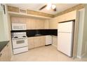 Functional kitchen featuring ample cabinetry and white appliances for a clean, cohesive look at 4513 S Oak Dr # Q31B, Tampa, FL 33611