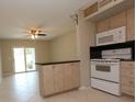 Well-lit kitchen with appliances and a breakfast bar open to the dining area at 4513 S Oak Dr # Q31B, Tampa, FL 33611