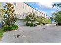Modern townhome featuring an attached garage, driveway, and manicured landscaping at 4911 N Nebraska Ave, Tampa, FL 33603