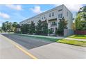 Long shot of a modern apartment complex with street view on a sunny day with blue skies at 4911 N Nebraska Ave, Tampa, FL 33603