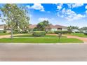 Inviting single-story home showcasing a winding brick driveway and beautifully landscaped yard at 5112 Lanai Way, Tampa, FL 33624