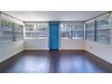 Bright sunroom with large windows and dark wood floors at 520 4Th Nw St, Largo, FL 33770