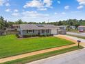 Aerial shot of a well-kept home with a green lawn and driveway at 6246 Bandura Ave, New Port Richey, FL 34653