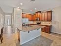 Spacious kitchen featuring a large island with granite countertops and stainless-steel appliances at 6912 40Th N Ln, Pinellas Park, FL 33781