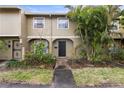 Charming townhouse with lush landscaping and a welcoming covered front entryway at 7606 Woodbridge Blvd, Tampa, FL 33615
