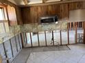 Kitchen area with stainless microwave, tile flooring, cabinets, and ready for renovation at 8422 Boxwood Dr, Tampa, FL 33615