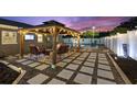 Outdoor living space with a stylish pergola, comfortable seating, and pavers perfect for entertaining at 895 Joan St, Dunedin, FL 34698