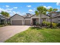 Charming single-Gathering home with a two-car garage, brick paver driveway, and meticulously maintained lawn at 923 Whimbrel Run, Bradenton, FL 34212