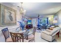 Open floor plan with a dining area and living room, featuring neutral walls and tile flooring at 10037 62Nd N Ter # 9, St Petersburg, FL 33708