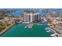A waterfront condo building with a pool, boat docks, and lush landscaping offers luxurious living at 10355 Paradise Blvd # 412, Treasure Island, FL 33706
