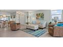 Cozy living room featuring comfortable seating, light wood floors, and tranquil decor with a view at 10355 Paradise Blvd # 412, Treasure Island, FL 33706