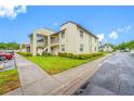A well-manicured lawn and shrubbery accent this two-story condo building's exterior at 1100 E Bay Dr # 60, Largo, FL 33770