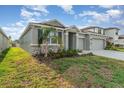 Charming single-Gathering home features stone accents and a lush front yard at 12436 Shining Willow St, Riverview, FL 33579