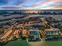 Aerial shot of buildings with ocean views, a marina, and waterfront access at 125 Island Way # 502, Clearwater Beach, FL 33767