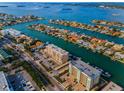 An areal view of a condo building situated on the water among beautiful homes and waterfronts at 125 Island Way # 502, Clearwater Beach, FL 33767