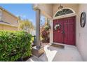 Inviting front entryway with double doors, decorative wreath, and a charming welcome mat at 1313 Key West Ct, Wesley Chapel, FL 33544