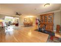 Spacious living area featuring hardwood floors, a dining table, and an exercise machine for a comfortable living experience at 1891 Harmony Dr, Clearwater, FL 33756