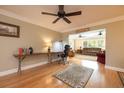 Inviting home office space with hardwood floors, natural light, and an open view to the connected living room at 1891 Harmony Dr, Clearwater, FL 33756